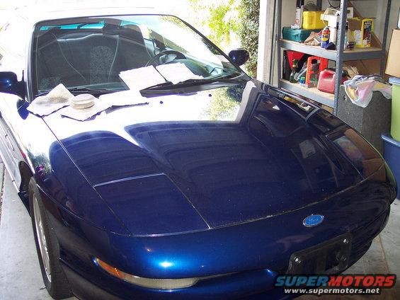 Blue 1995 Ford Probe hood with papers on it