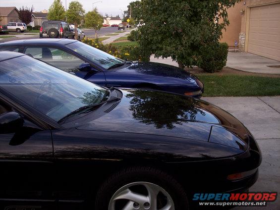 Two blue 1995 Ford Probes parked in a driveway