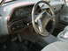 1988 Ford Bronco - The dashboard and interior of a 1988 Ford Bronco, wood grain trim and gray upholstery.