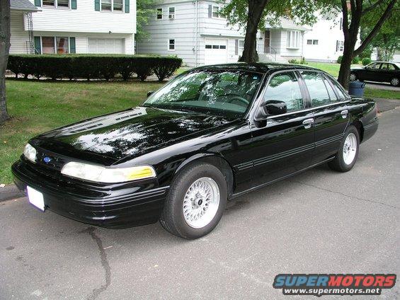 Black 1997 Ford Crown Victoria parked on a residential street
