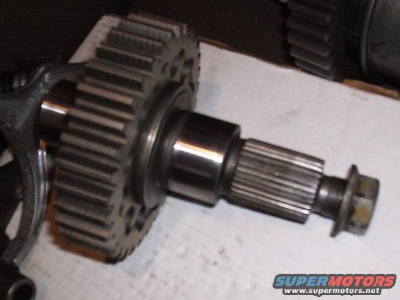 Close-up of a transfer case gear and splined shaft with a bolt