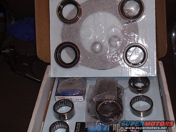 Box of assorted bearings and seals, some in plastic packaging, others loose