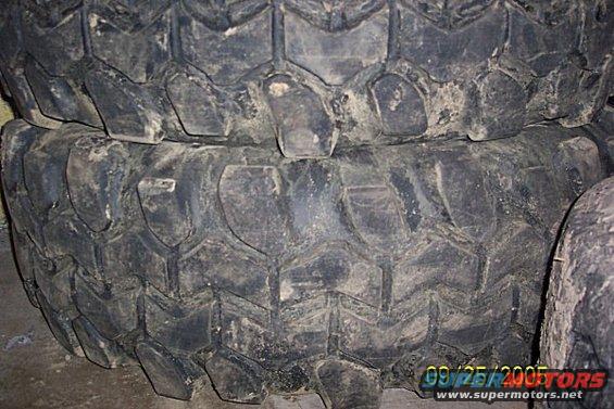 Stack of two large off-road tires with aggressive tread pattern. Date stamp 09/25/2005 visible