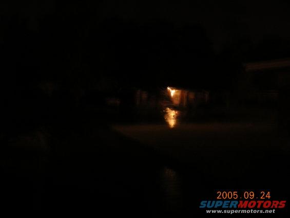 streetlights reflecting on flooded road at night