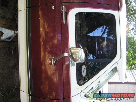 1991 Ford Bronco side door with chrome handle, side mirror, and Ford badge on window