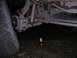 1994 Ford Bronco - The underside of a vehicle is visible, with a tire and a jack placed nearby.
