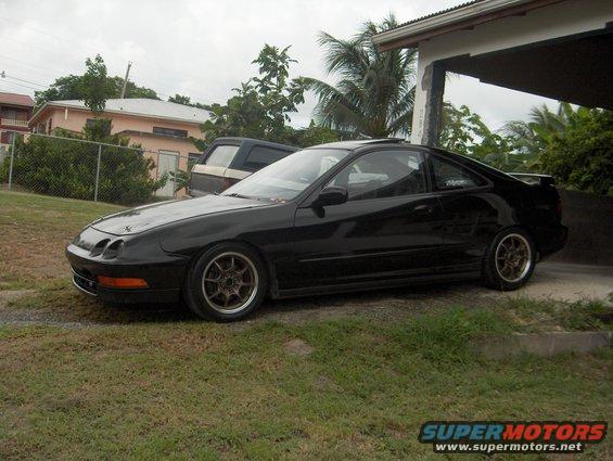 1994 Acura Integra coupe parked on grass, side view