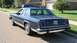 1985 Ford Crown Victoria LTD - Rear view of a blue 1985 Ford Crown Victoria LTD sedan parked on a suburban street, showing its distinctive taillights and chrome bumper.