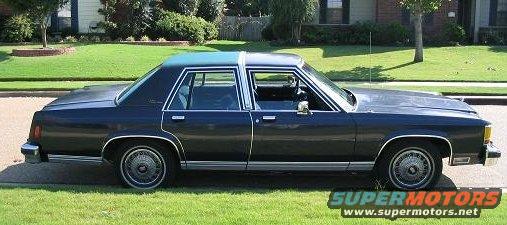 Dark blue 1980s Ford LTD Crown Victoria sedan parked on a grassy lawn