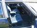 1985 Ford Crown Victoria LTD - Interior view of a sedan with blue velour seats and wood-grain trim on the dashboard.