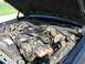 1985 Ford Crown Victoria LTD - The engine bay of a 1985 Ford Crown Victoria LTD is visible with the hood open.