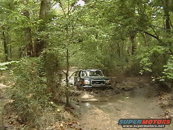 1986 Ford Bronco stuck in muddy trail