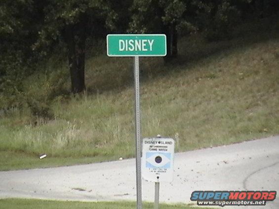 Disney street sign above a Disney Island Game Watch sign