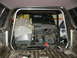 1992 Ford Bronco - The interior of a 1992 Ford Bronco shows a rollcage, exposed wiring, and a disassembled dashboard.