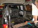1992 Ford Bronco - Interior view of a pickup truck undergoing modifications, showing a roll cage installation.