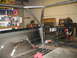 1992 Ford Bronco - A custom rollcage is being installed in the bed of a truck, with tools and supplies visible.