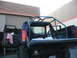 1992 Ford Bronco - The rear of a 1992 Ford Bronco is shown with the doors and tailgate open, revealing an installed roll cage.