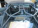 1992 Ford Bronco - The interior of a 1992 Ford Bronco shows a custom rollcage, racing seat, and exposed wiring, indicating modifications.