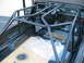 1992 Ford Bronco - The interior of a 1992 Ford Bronco features a custom rollcage, with the dashboard and steering wheel visible.