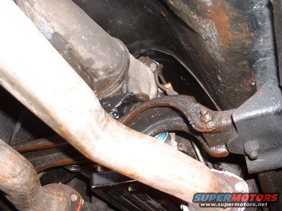 Exhaust pipes and suspension components under a vehicle