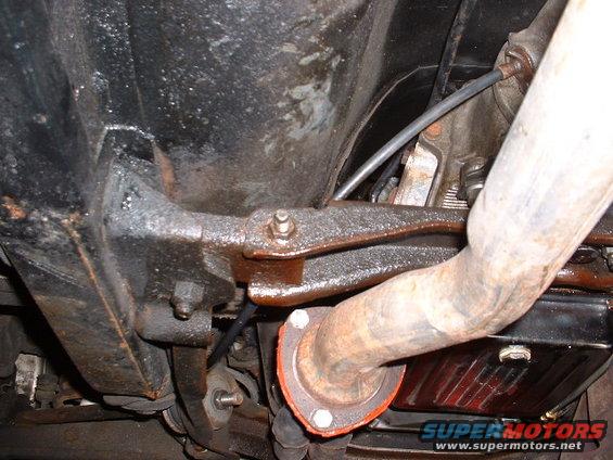 Underside view of a vehicle's exhaust pipe and suspension components