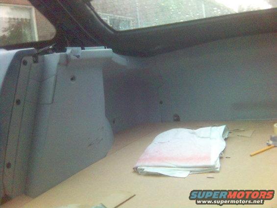 1994 Ford Probe trunk interior with light gray trim and tan carpeted floor