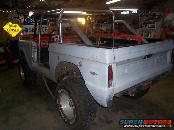 1974 Ford Bronco with roll cage, doors removed, in a garage