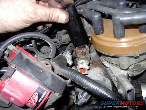 The stock temp sensor was clocked right over the T-stat housing. Using a 1" deep socket I just tightened the stock temp sensor tower so it pointed slightly to the left and I was back in business.