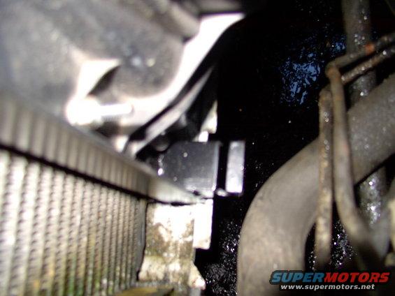 This pic is way out of focus, but maybe you can see the notched angle steel, ready to accept and locate the stock Lincoln overflow tank's lower tab.