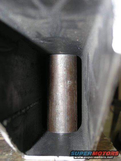 Close-up of a metal cylinder inserted into a dark, rectangular frame