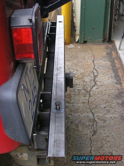 Red Jeep's rear bumper with a custom metal addition and license plate NT 245