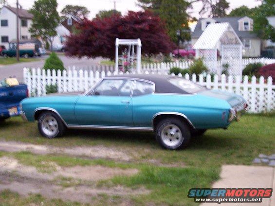 Teal 1970 Chevrolet Chevelle coupe with a black vinyl roof, parked on grass
