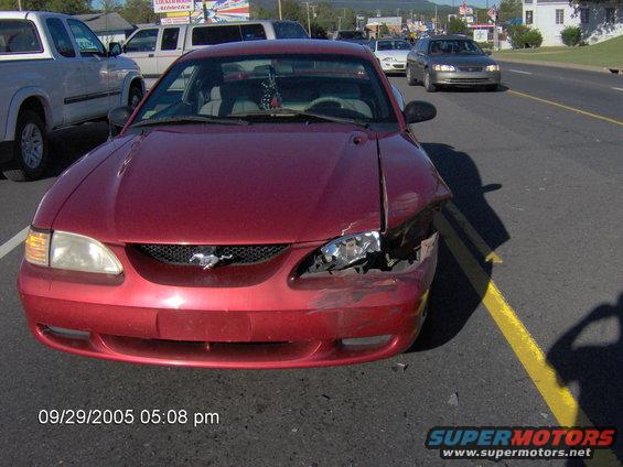 Red 1996 Ford Mustang with damaged front end