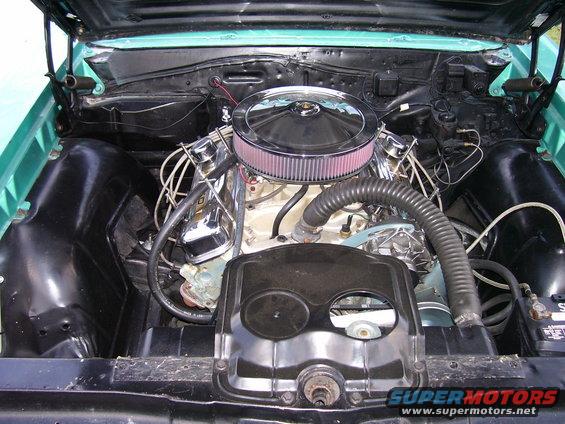 1967 Pontiac Lemans engine bay with chrome air cleaner and turquoise paint visible