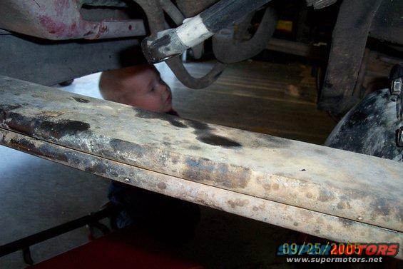 Baby peeking under a truck frame, 09/25/2005 timestamp