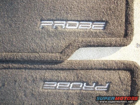 Two gray car floor mats with "PROBE" embroidered in silver lettering