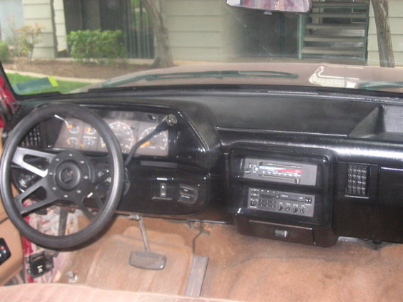 Interior dashboard with aftermarket steering wheel and dual-DIN radio