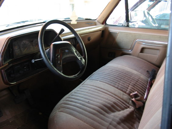 Interior view of truck with bench seat and steering wheel