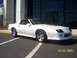 1988 Chevrolet Camaro - A white 1988 Chevrolet Camaro IROC-Z is shown parked outside a building.