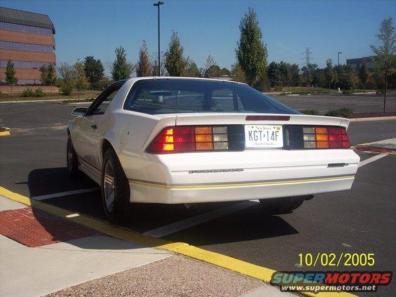 White 1988 Chevrolet Camaro rear view with gold trim