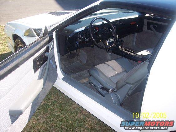 Interior of a 1988 Chevrolet Camaro, showing the dashboard, steering wheel, and seats