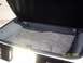 1988 Chevrolet Camaro - The trunk of a car is shown with the lid open, revealing the carpeted storage area.