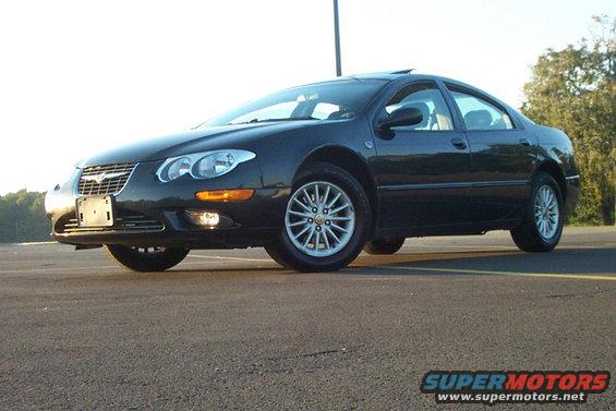 1999 Chrysler 300M sedan, dark color, parked outdoors. Front passenger side view