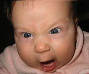 Close-up of a baby's angry face