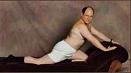 Man in white underwear posing on a dark surface against a textured background