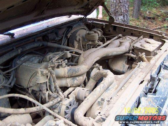 Mud-covered engine bay with visible date stamp 10/05/2005