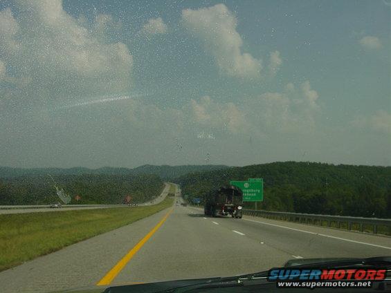 Truck on highway with green sign for Kingsbury Road