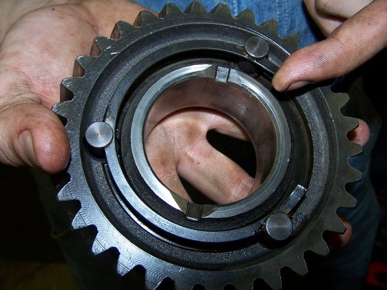 Close-up of a gear synchronizer ring and collar held by hands