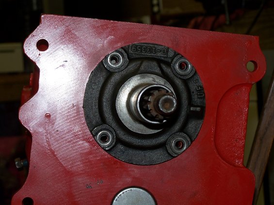 Close-up of a red metal part with a circular opening showing splines, part number C-13359 visible