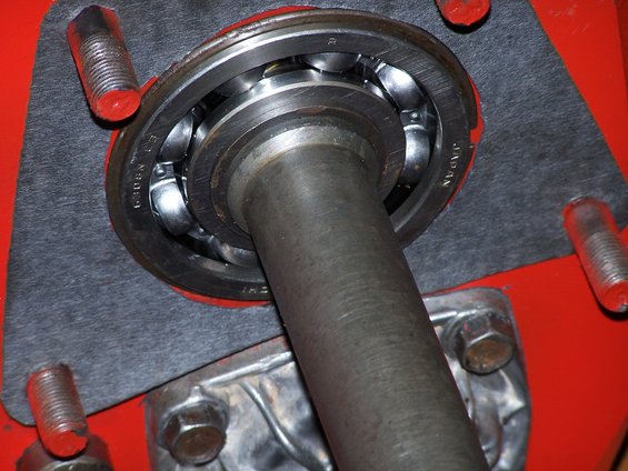 Close-up of a ball bearing assembly with a metal shaft passing through it. Text on the bearing reads "JAPAN" and "6308N"